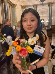 Undergraduate student Christina Huang holding flowers at 3050 Gala Dinner